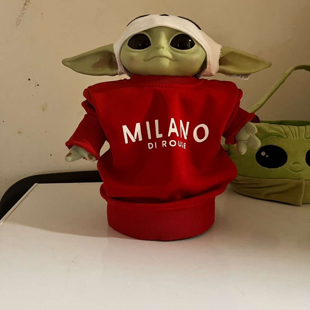 Grogu/Baby Yoda in fashion. He has a Milano sweater on he can also talk and walk
